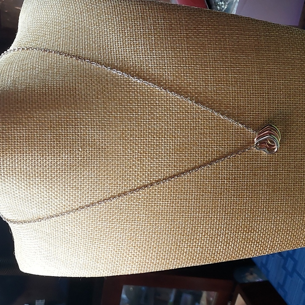 Silver tone necklace with triple heart pendant